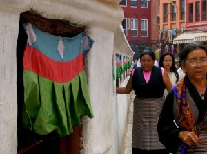 Tibetan women spin prayer wheels in Boudanath